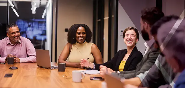 Working professionals sitting around a table. 