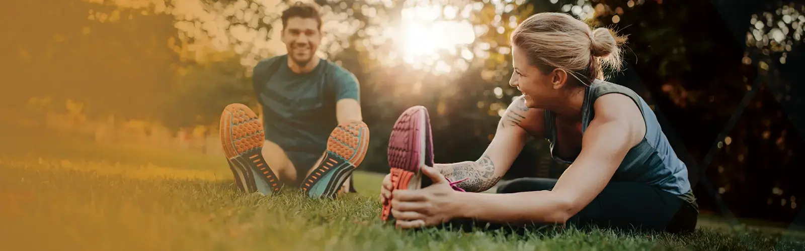 Young couple doing their stretches in the park 