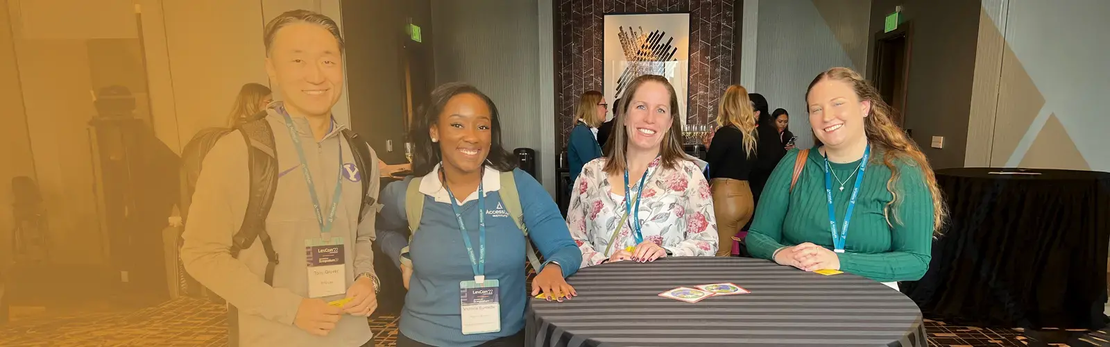 Group of professionals standing at a table at a Conference  