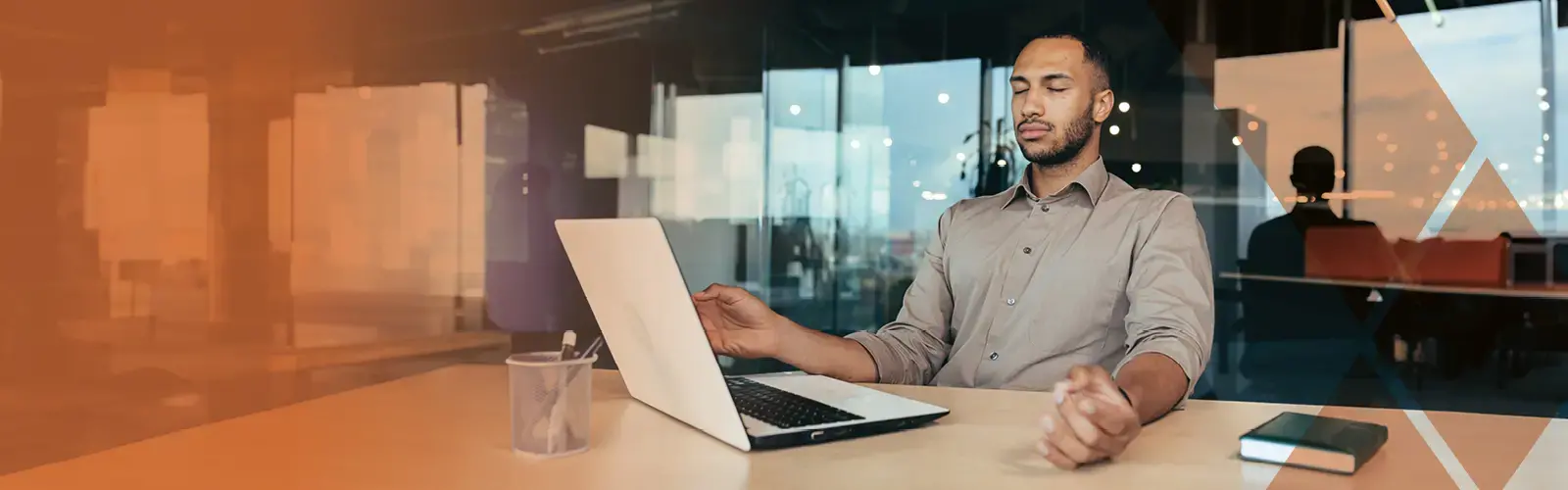 Business person working inside modern office building meditating with eyes closed sitting on chair 
