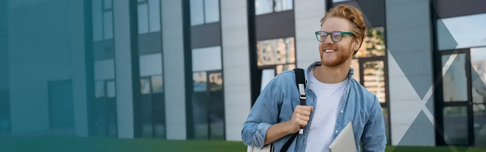 Student walking with backpack and laptop 