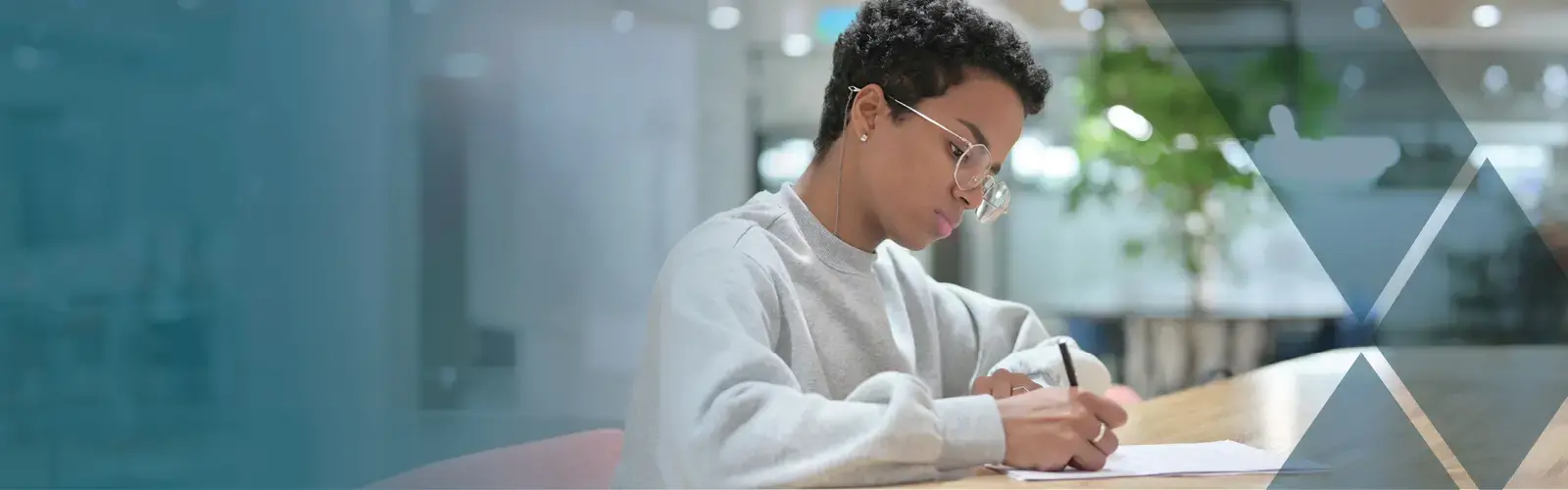 Young adult writing on paper 