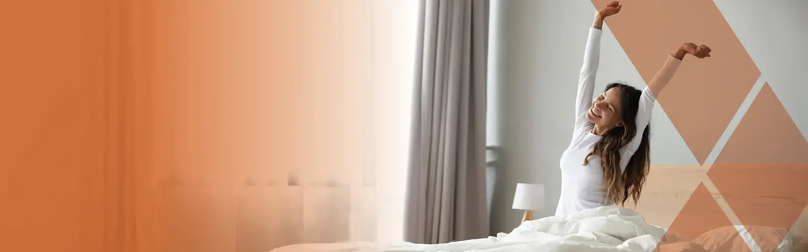 Person sitting in bed stretching arms after sleep 
