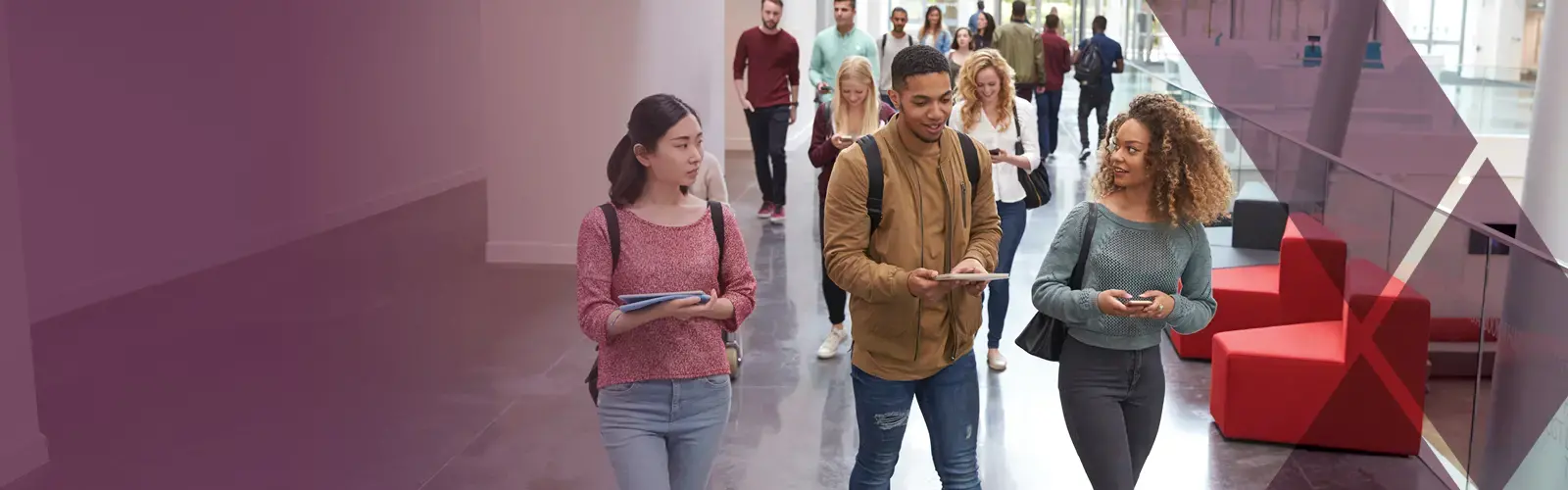 three students walking inside a building