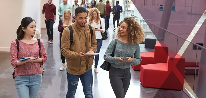 three students walking inside a building