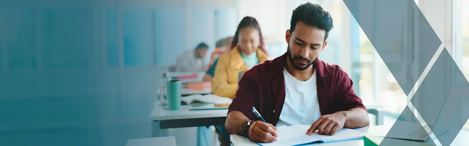 Students sitting in a row of desks taking an exam