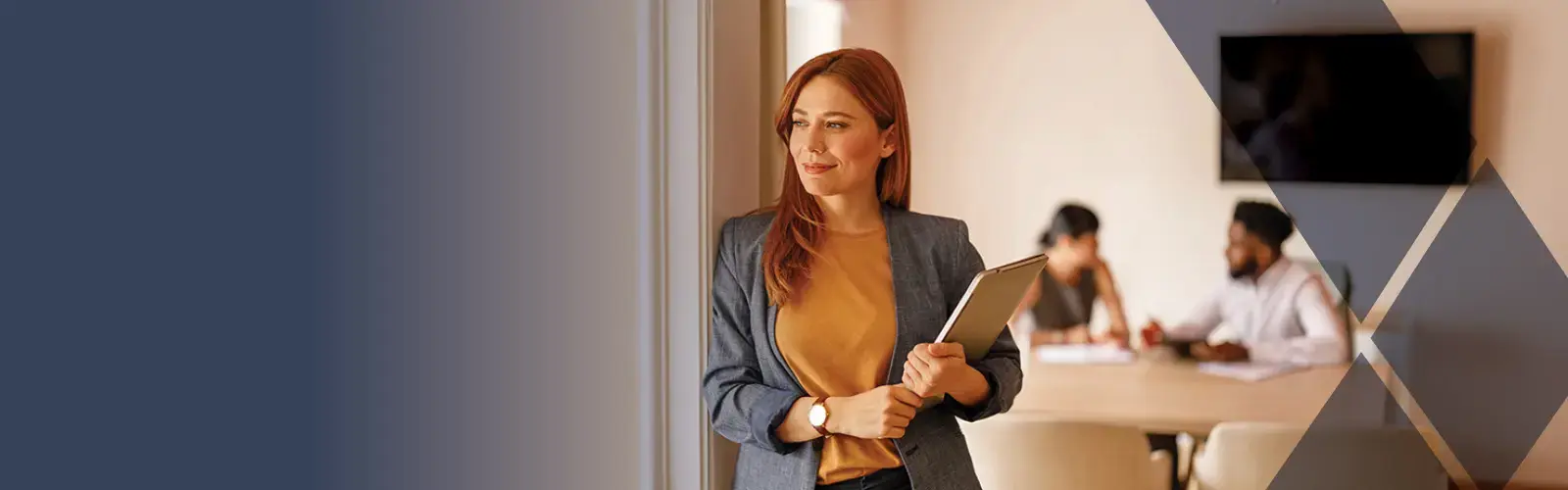 Thoughtful lawyer laptop looking away confidently while leaning on wall with colleagues in the background