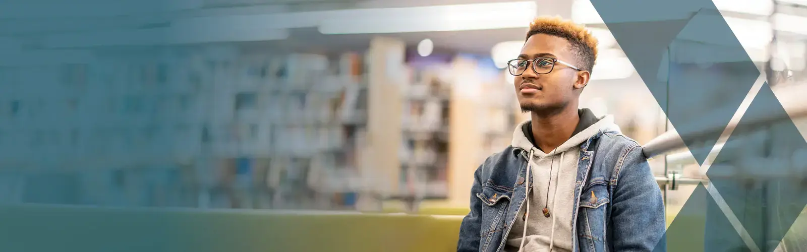 Law student sitting in a library looking off into the distance. 